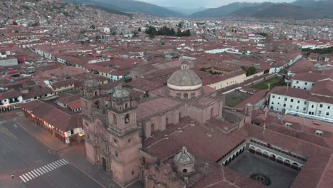 4k daytime aerial drone footage with the church of the society of jesus from plaza de armas in cusco, peru during coronavirus lockdown