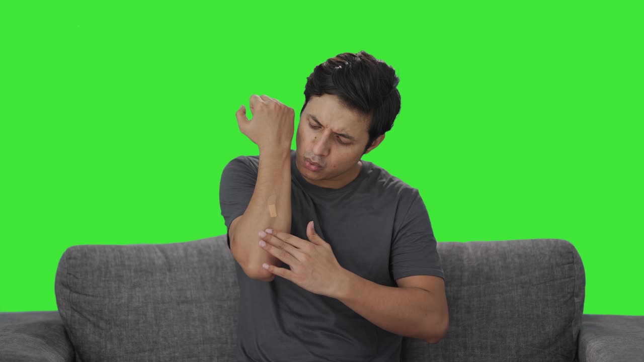 Indian man putting bandage on wound Green screen