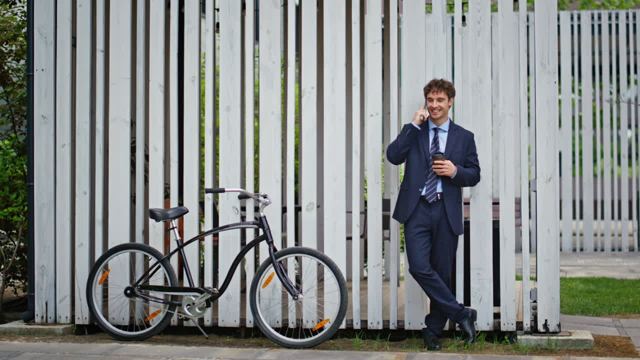 Businessman make phone call near bicycle outdoors. Manager talking cellphone