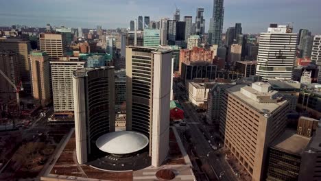 aerial view of toronto city hall and downtown skyscrapers, wide dolly in