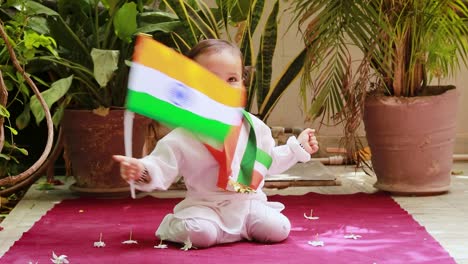 cute-toddler-waving-indian-tricolor-flag-in-traditional-cloth-with-innocent-facial-expression