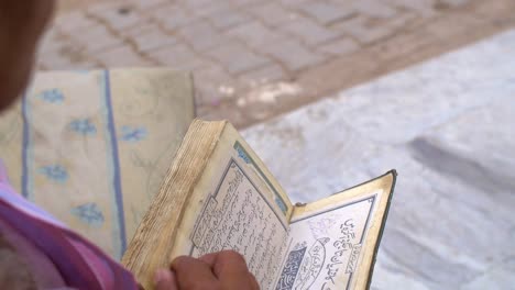 Man-Looking-Through-Quran