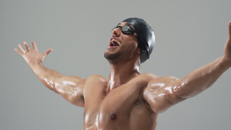 Exuberant young biracial athlete swimmer celebrates a victory in swimming