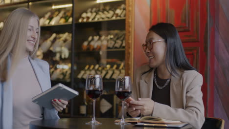 businesswomen enjoying a wine tasting in a modern wine bar