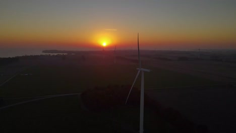 group of wind windmill electricity energy power generators during sunrise