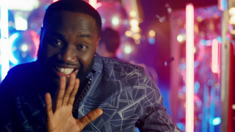 African-american-guy-dancing-under-confetti.-African-man-partying-in-disco-club