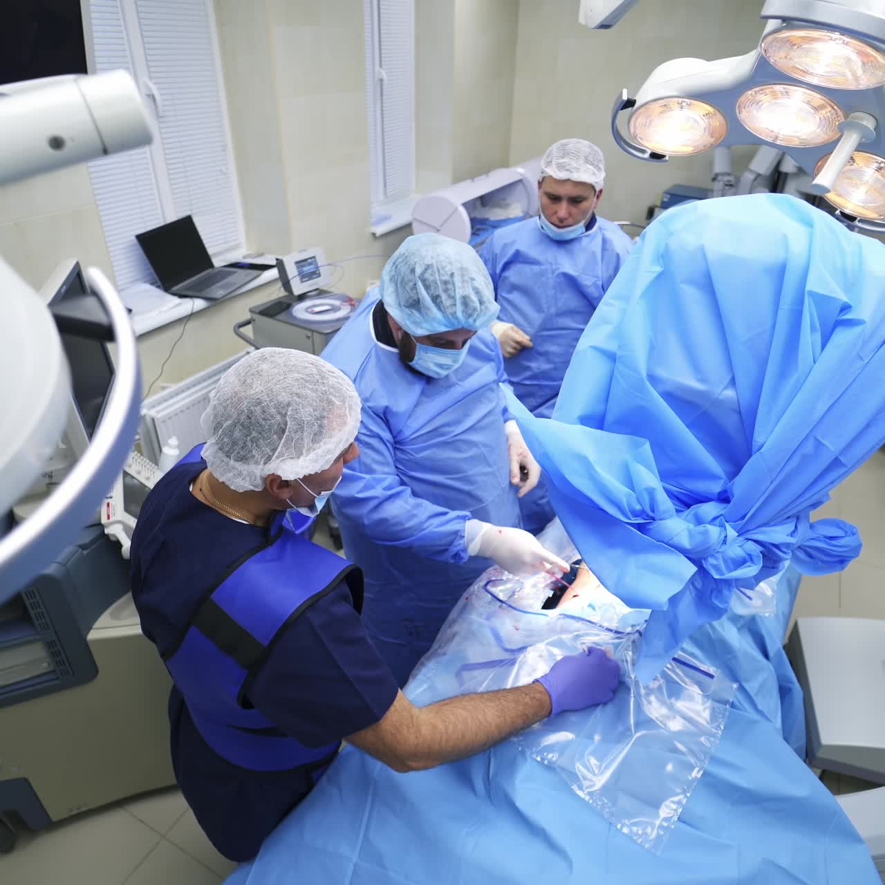 Operation room with specialists. Teamwork of surgeons performing operation on the background of modern equipment in private clinic