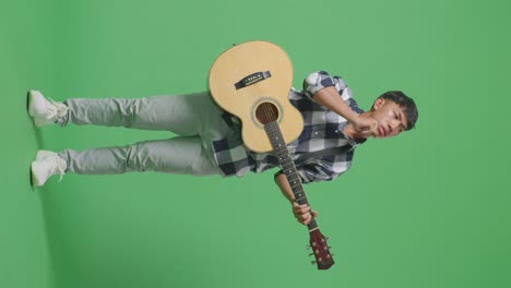 man playing acoustic guitar in studio
