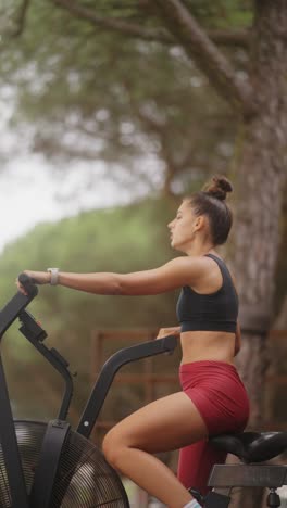 woman exercising on an air bike outdoors