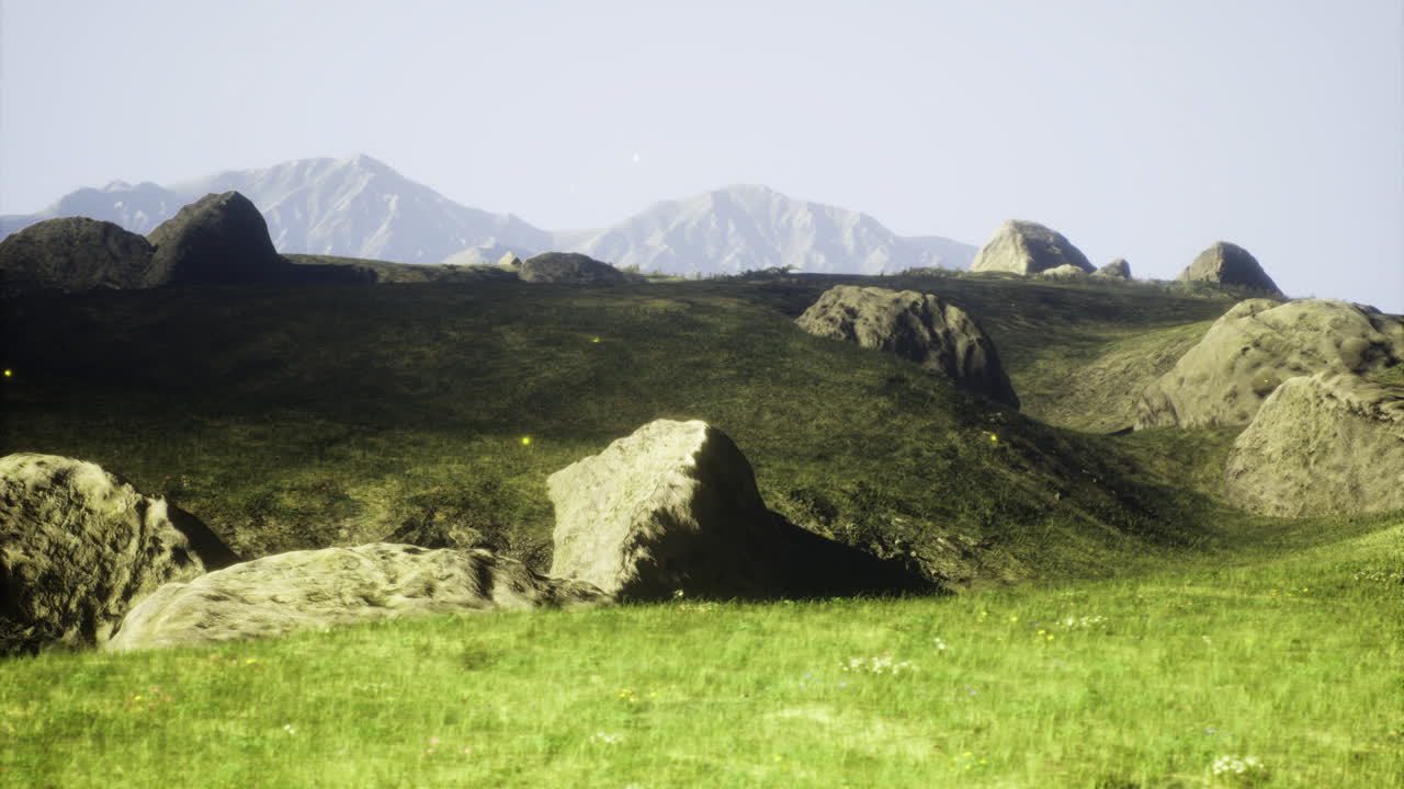 Lush green landscape with rocky outcrops and distant mountains in daylight