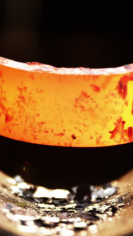 close-up of blacksmith working on a iron rod