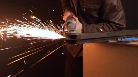 metal-on-table-flaming-with-grinder-machine,-still-medium-shot