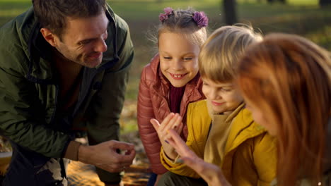 family having fun together in the park during autumn