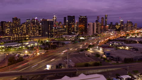 hyperlapse across melbourne city highway toward building with heart lights display