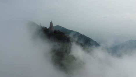 the old pagoda in ba vi national park is covered by clouds