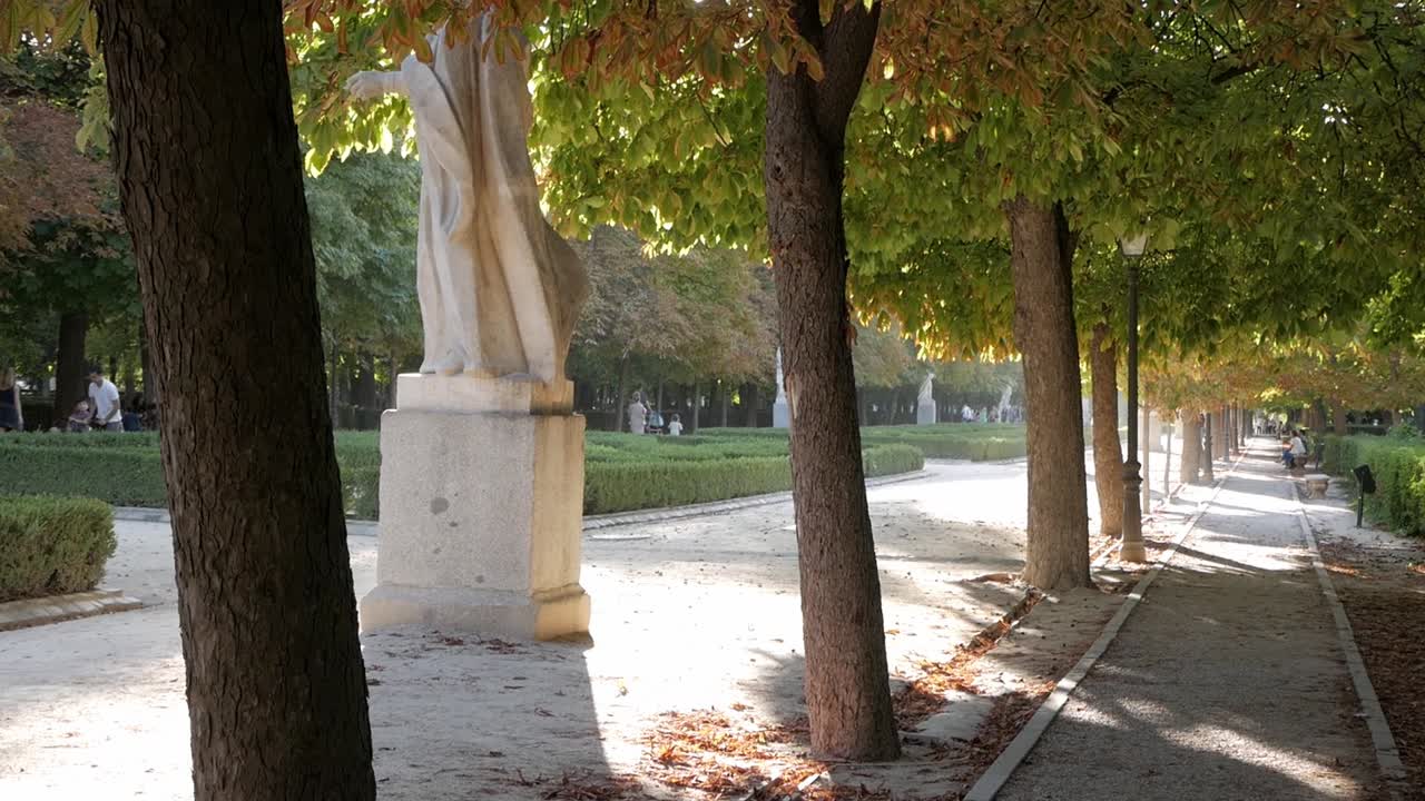 Sunny Day in a Park with a Statue and Walking Path