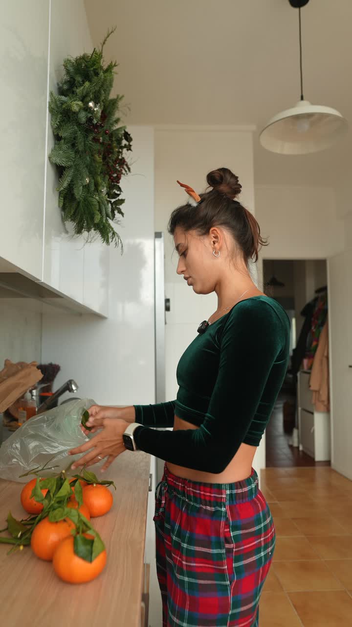 Woman with oranges in a kitchen