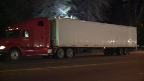 an unmarked double tractor trailer truck drives through the night 1