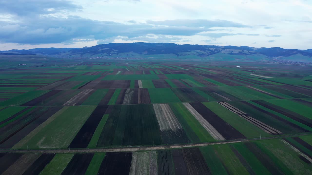 Picturesque patchwork fields. Aerial forward