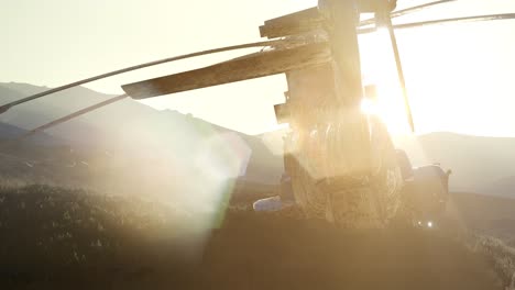 old-rusted-military-helicopter-in-the-desert-at-sunset