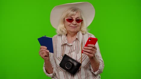 mature woman traveler tourist browsing on mobile phone and looking for holiday resort vacation trip
