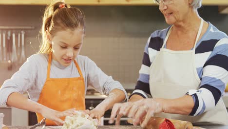 happy grandmother and child kneading dough for cookies 4k 4k