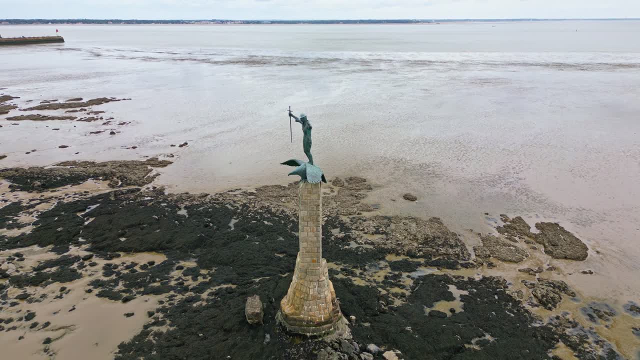 Approaching drone movement to the iconic American monument aka Le Sammy in shallow water during low tide, Saint-Nazaire, Loire-Atlantique, France