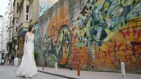 bride walking through a graffiti-covered alley in istanbul