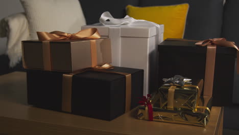 close up of gift wrapped presents on table in lounge at home 4