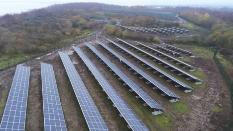 Solarpanel-Array-Reihen-Luftaufnahme-Neblige-Herbstwaldlandschaft-überfliegen