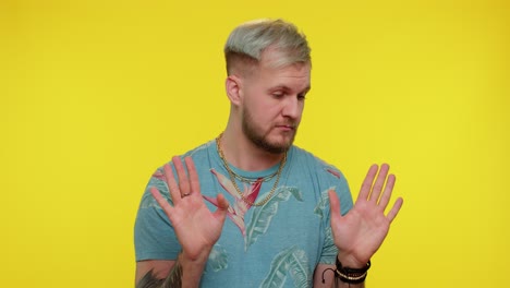 man on yellow studio background pointing fingers himself ask say who me no thanks i do not need it