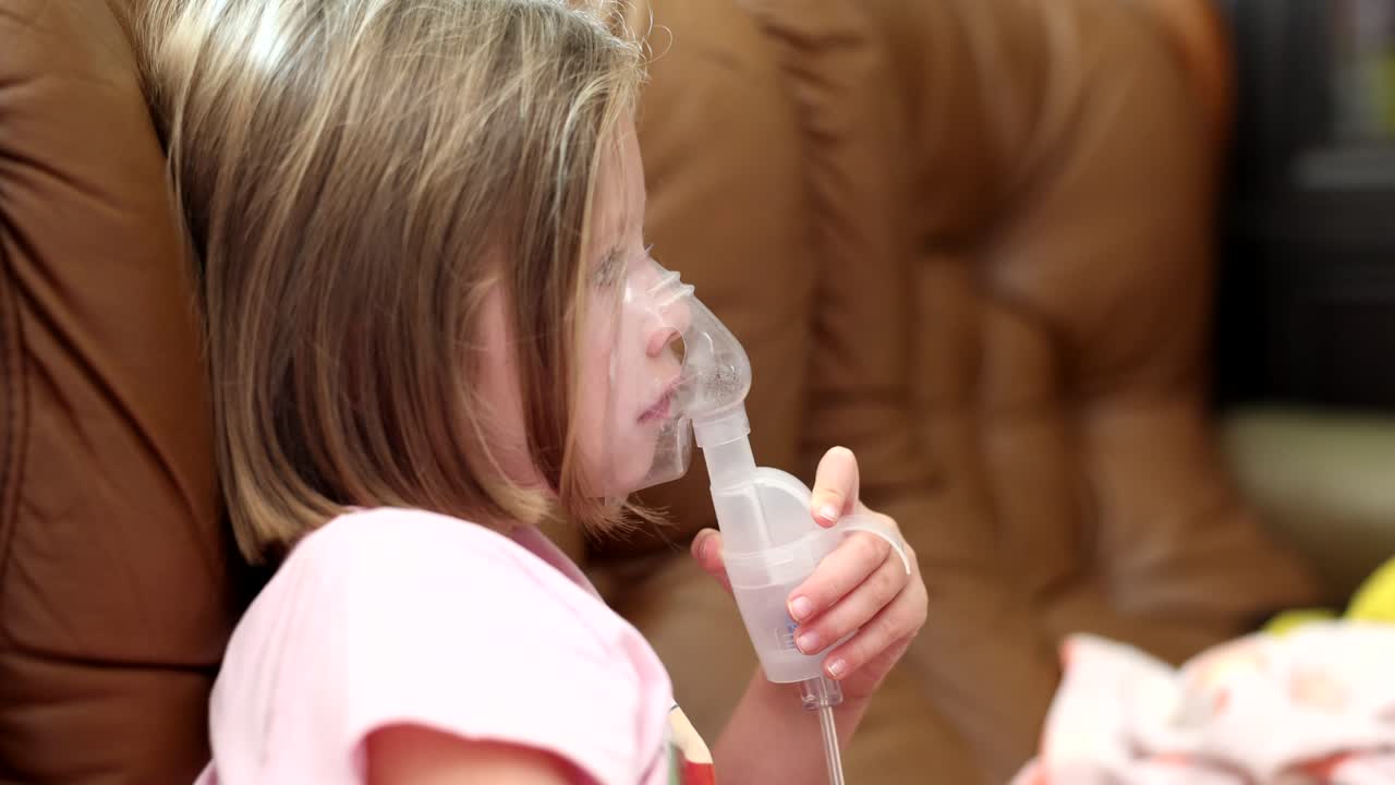 Child using nebulizer for respiratory treatment
