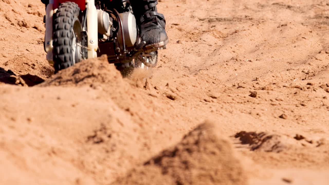 motociclista navegando por una pista de arena fuera de carretera