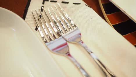 close up of two forks on a white napkin