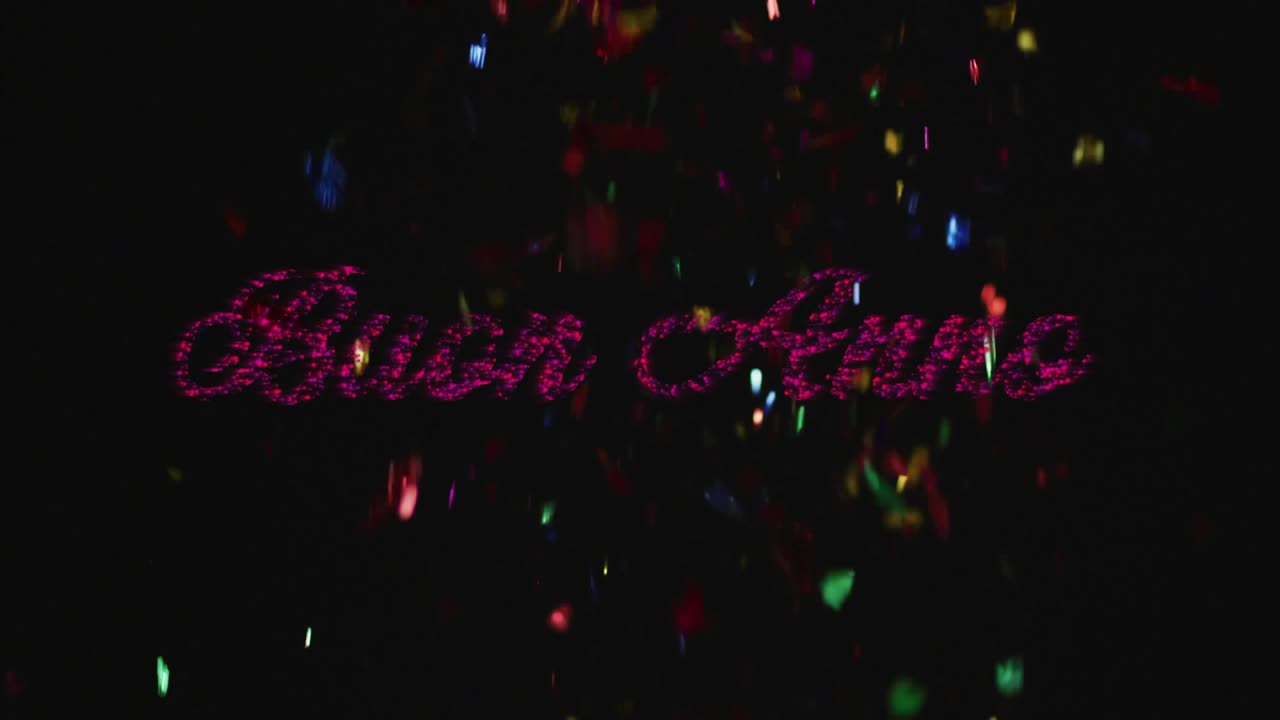 Dark void starting with red particles forming cursive Buon Anno while confetti falling, swirling