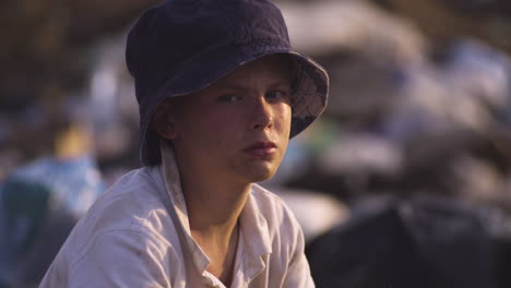 a boy in a hat holding a stick