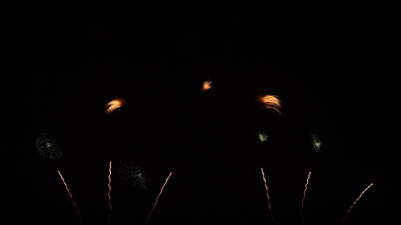 Real fireworks on deep black background sky, beautiful colorful fireworks shiny display at night, real time 4k footage.