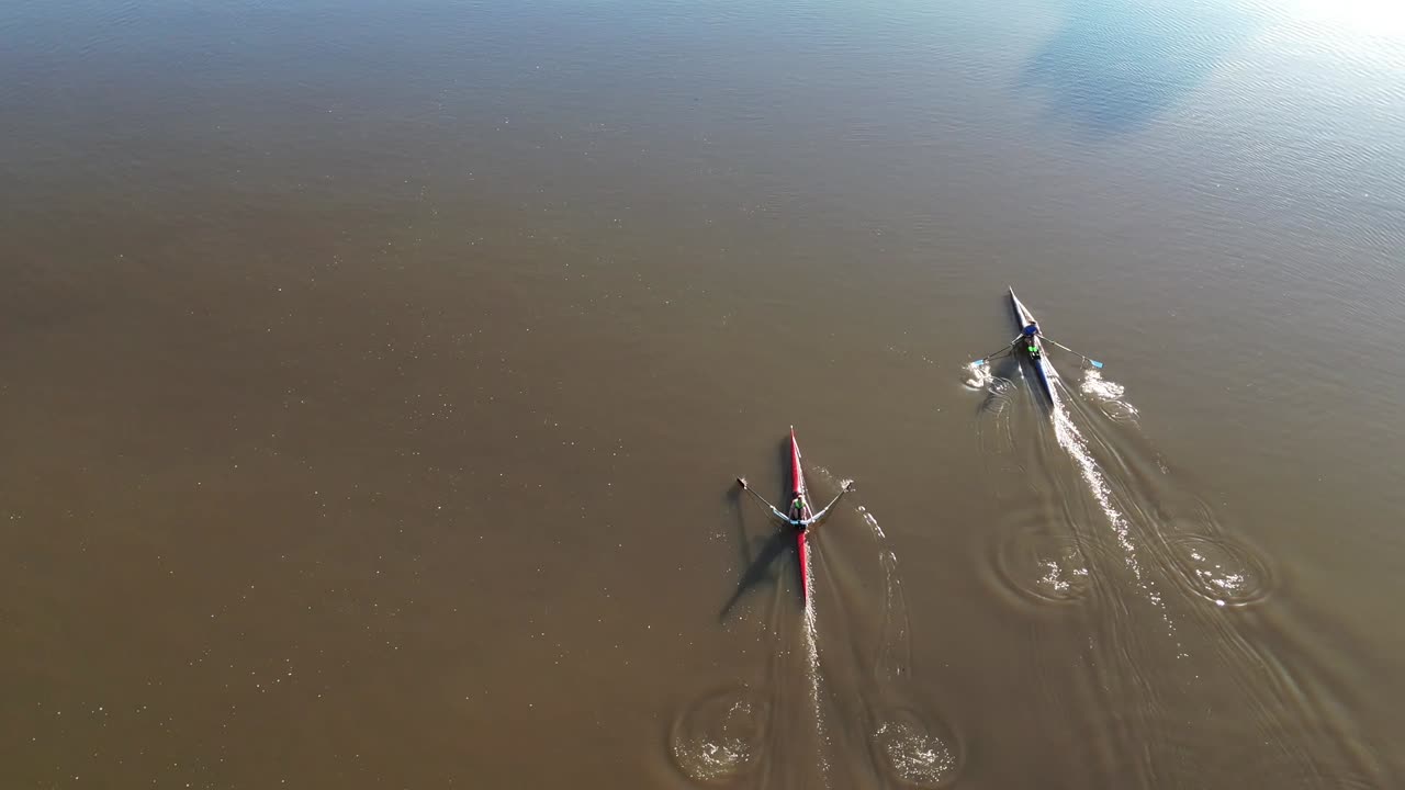 Rowers on sculls in the Fox River., DE Pere, WI, USA