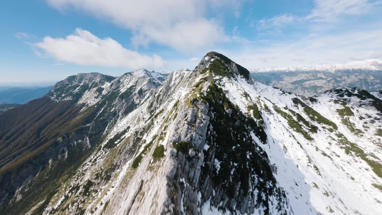 Flight right by the edge of a mountain peak in Triglav National Park in Slovenia