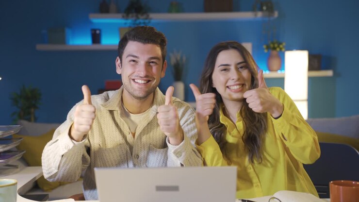 The happily married couple confirming the good news make the okay sign.