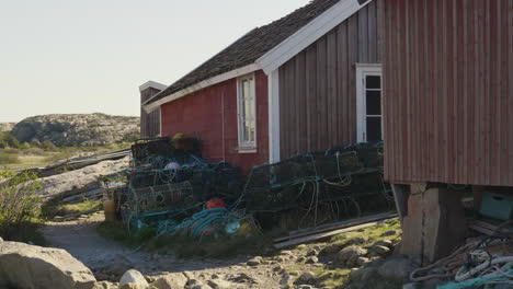 swedish west coast red fisherman’s hut and lobster pots