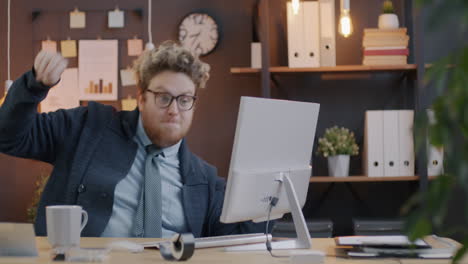 Excited Businessman Celebrating at Computer