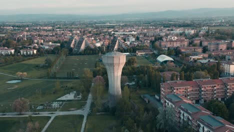 Aerial-–-Orbit-around-a-water-tank-tower-in-a-city-park-during-sunset