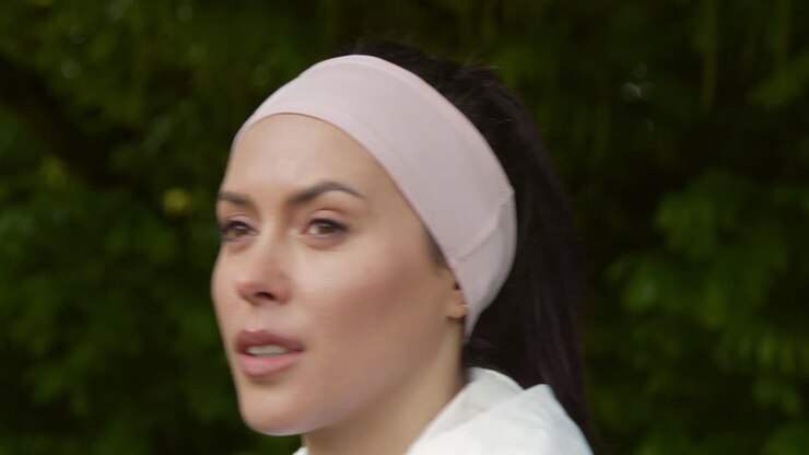 Close Up Of Woman Wearing Headband Exercising Keeping Fit Running In Countryside Or Park