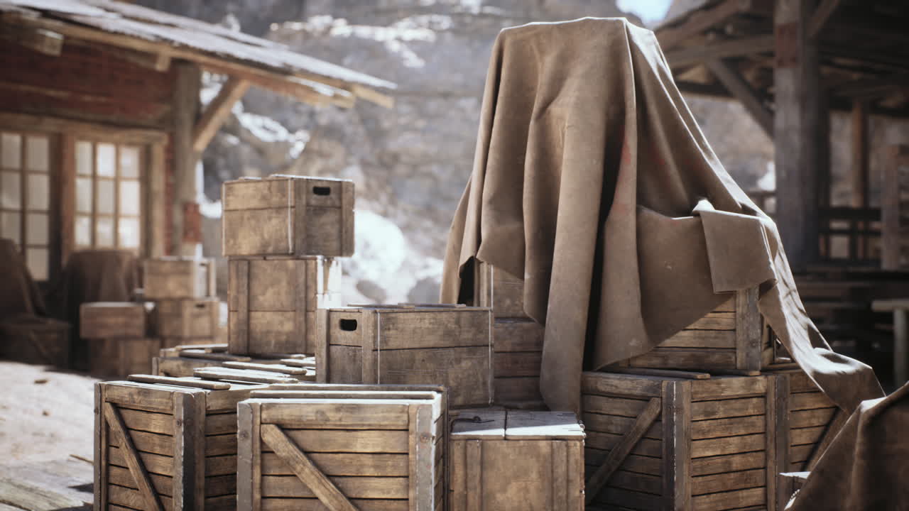 Wooden crates covered with a cloth in an abandoned warehouse during daylight