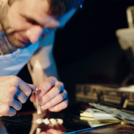 drug business. man holding a folded bill for sniffing and snorting the line. square video