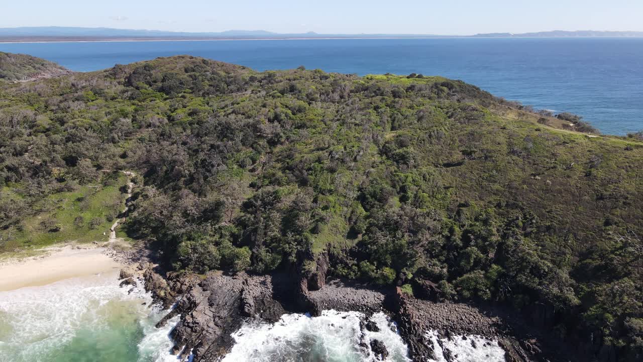 Aerial drone above Noosa park, revealing sparkling blue ocean on a sunny day