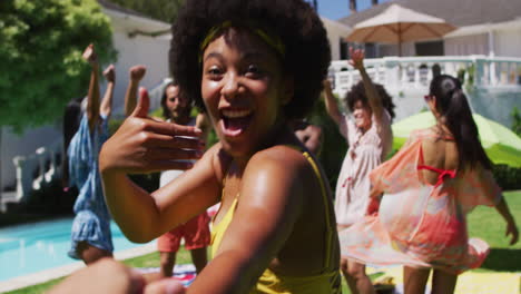 Diverse-group-of-friends-having-fun-and-dancing-at-a-pool-party