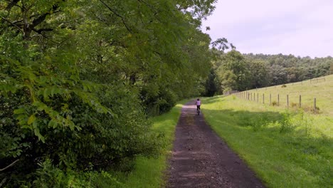 Woman-rides-bike-on-new-river-trail-near-galax-virginia