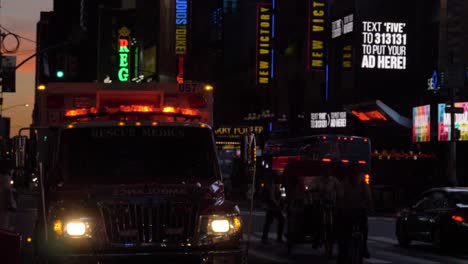 fdny ambulance car parking with glimering red lights at broadway near theatres lit by  in manhattan, new york city, filmed in 180 fps slow motion at dusk
